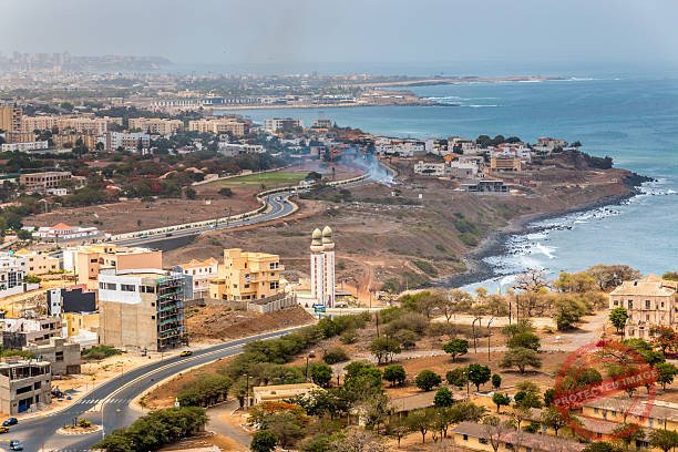 Aerial view of the city of Dakar, Senegal, showing the densely packed buildings and a highway Dakart ville verte
